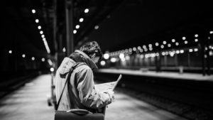 person at a train station at night